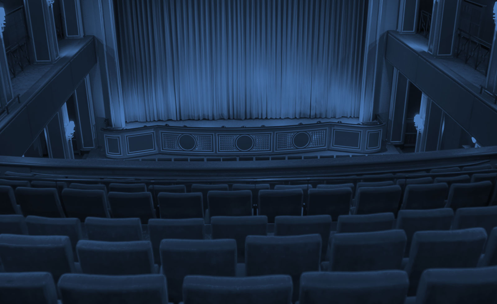 Decorative Banner - an empty theater viewed from behind balcony seating